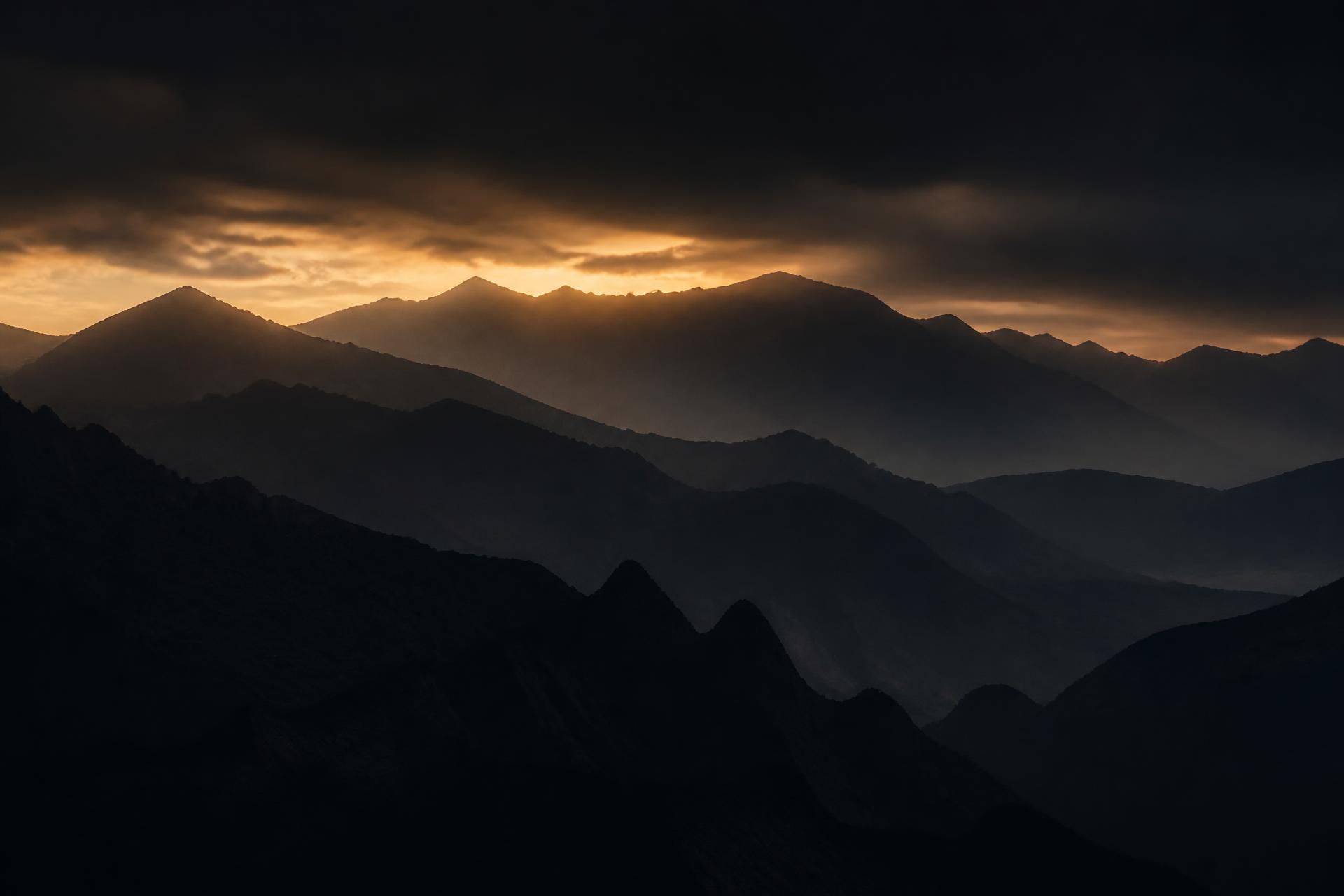 Layered mountain ridgelines at first light
